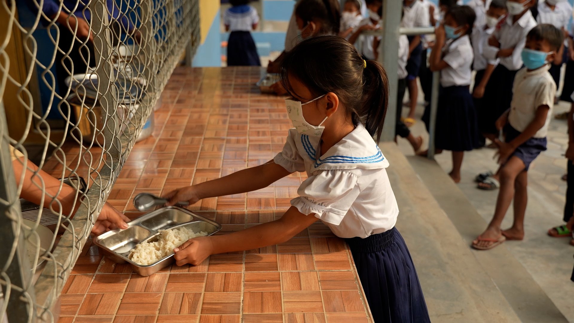 Girl receives her meal provided by World Food Programme's school meals programme