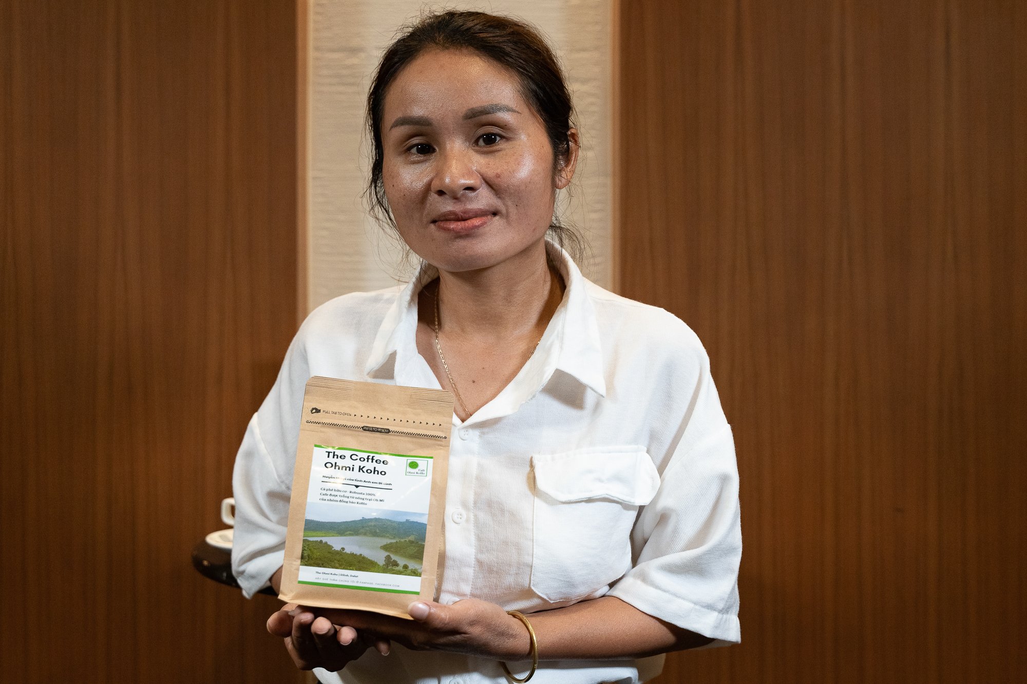 A female CO:LAB participant poses for  a photo of her with the coffee that she makes