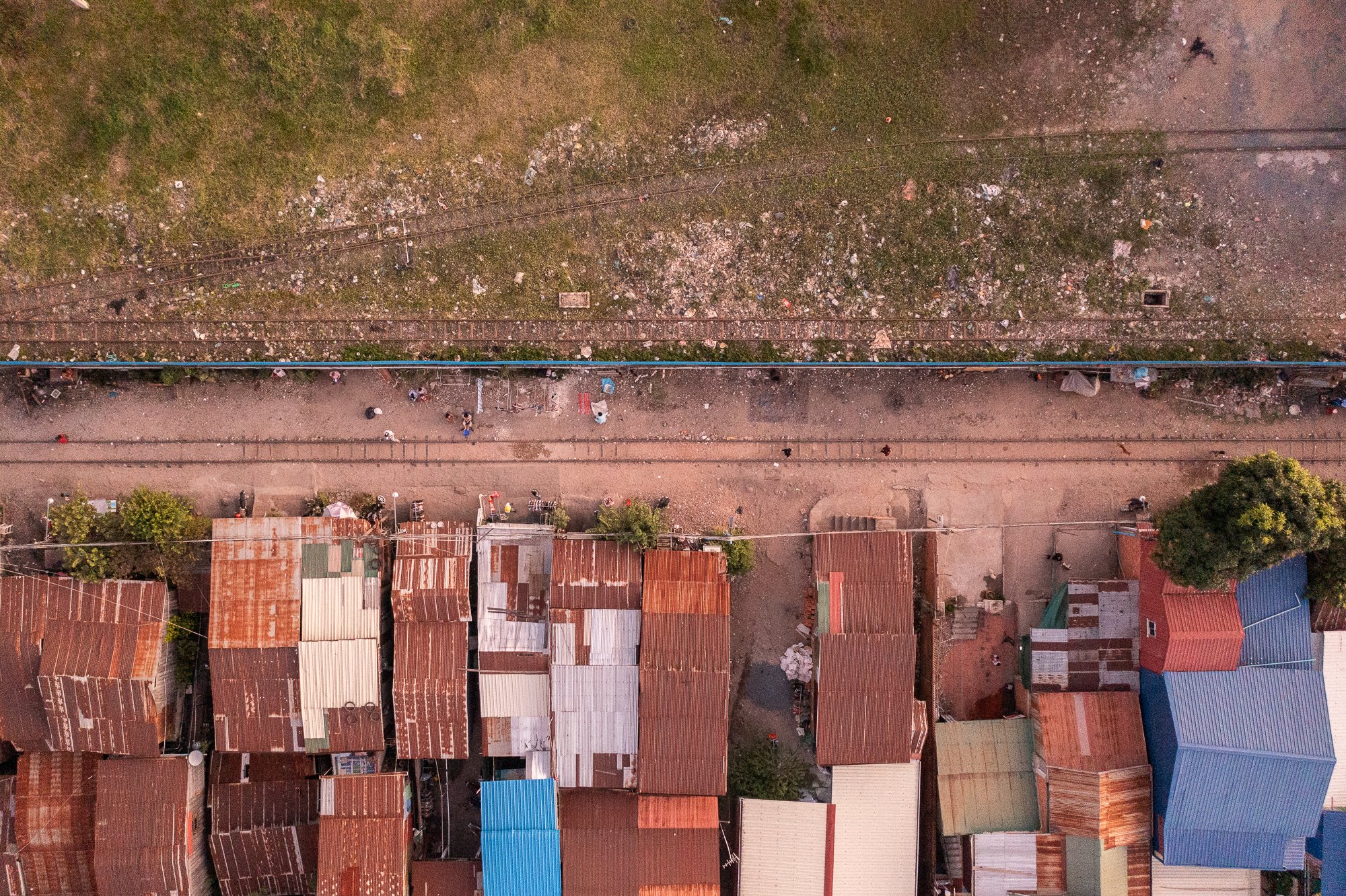 A top down view of the rail tracks with metal shacks lining the route, Phnom Penh, Cambodia