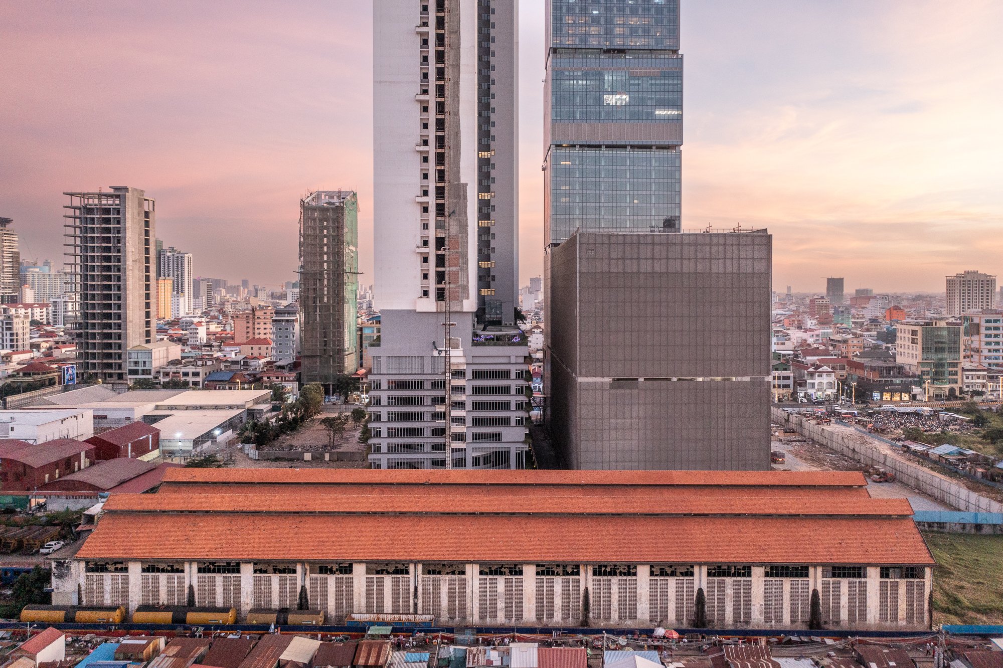 A aerial view of Phnom Penh to the south with the railway service center in the foreground and construction in the background.