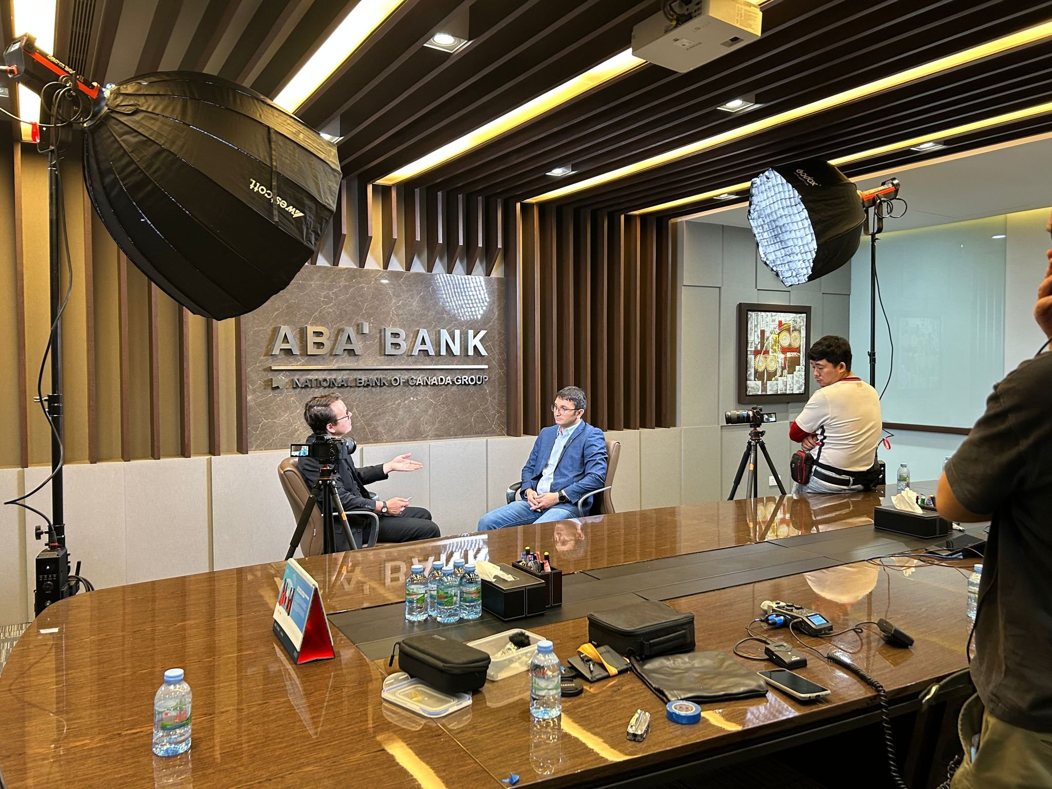 George working as a lighting camera op filming a corporate interview ABA Cambodia