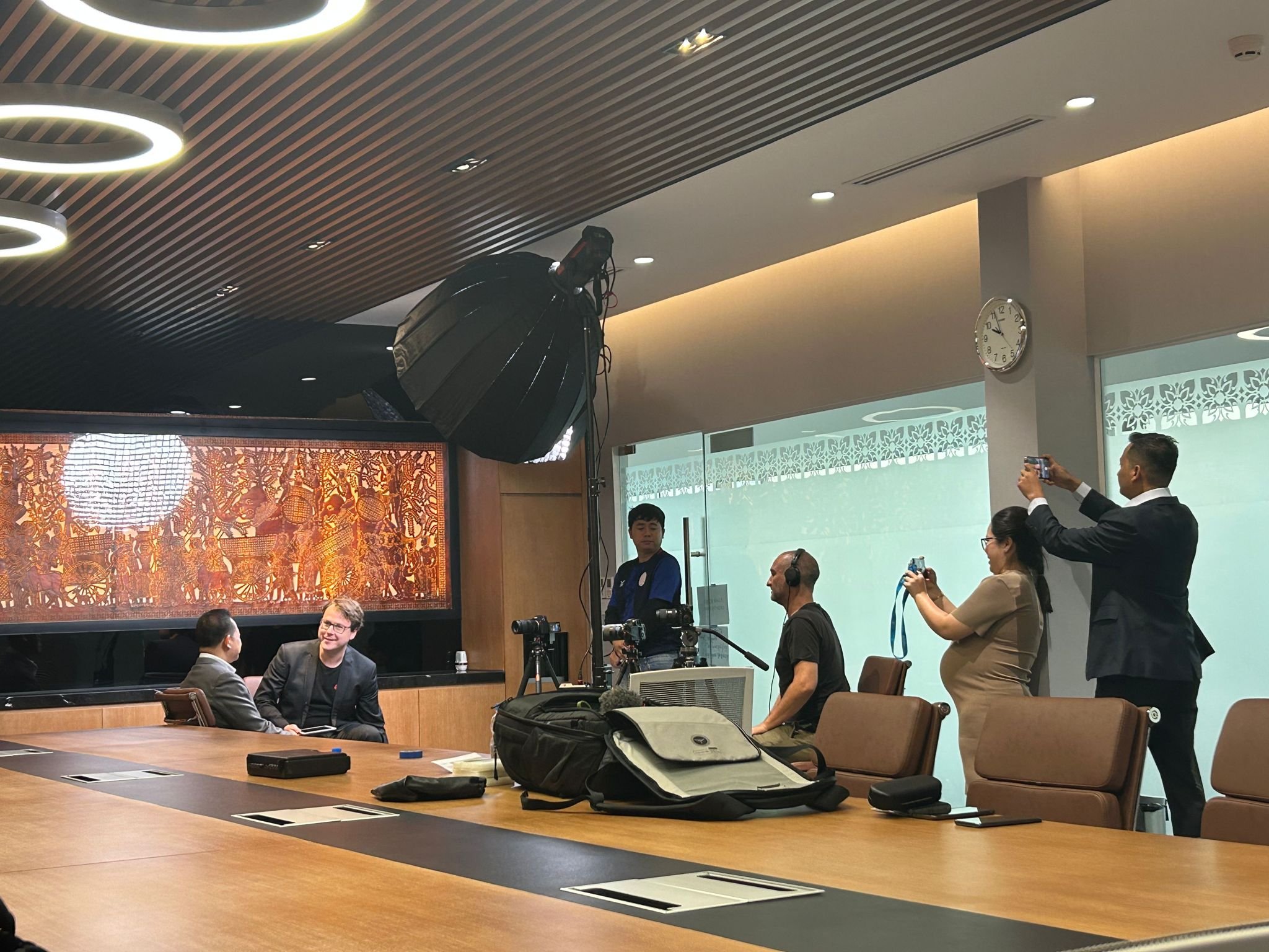 George lighting, filming and recording sound for a corporate interview at JTrust's HQ in Cambodia