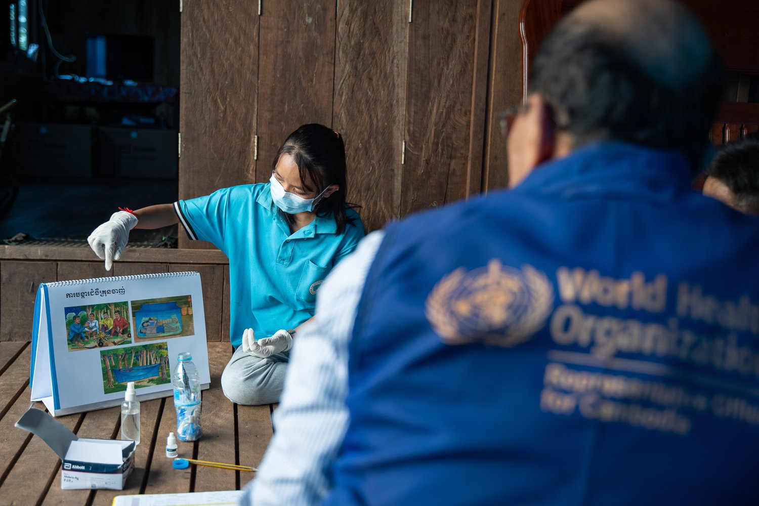 Sophal monitors a training session about malaria prevention in a remote community