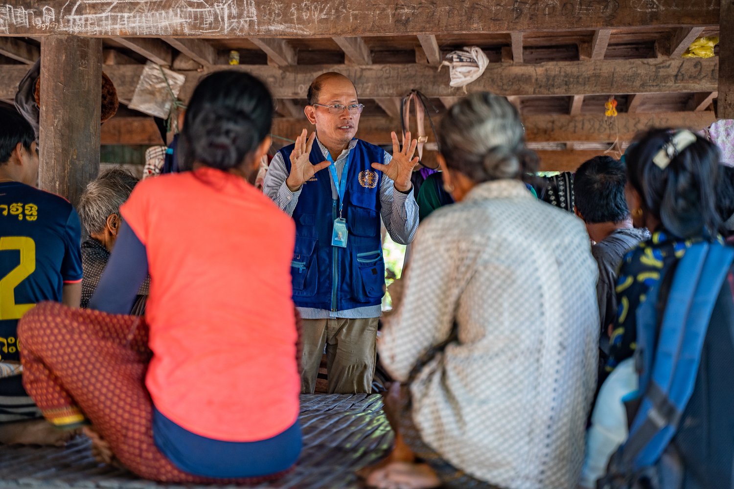 Sophal speaks to a community about malaria prevention