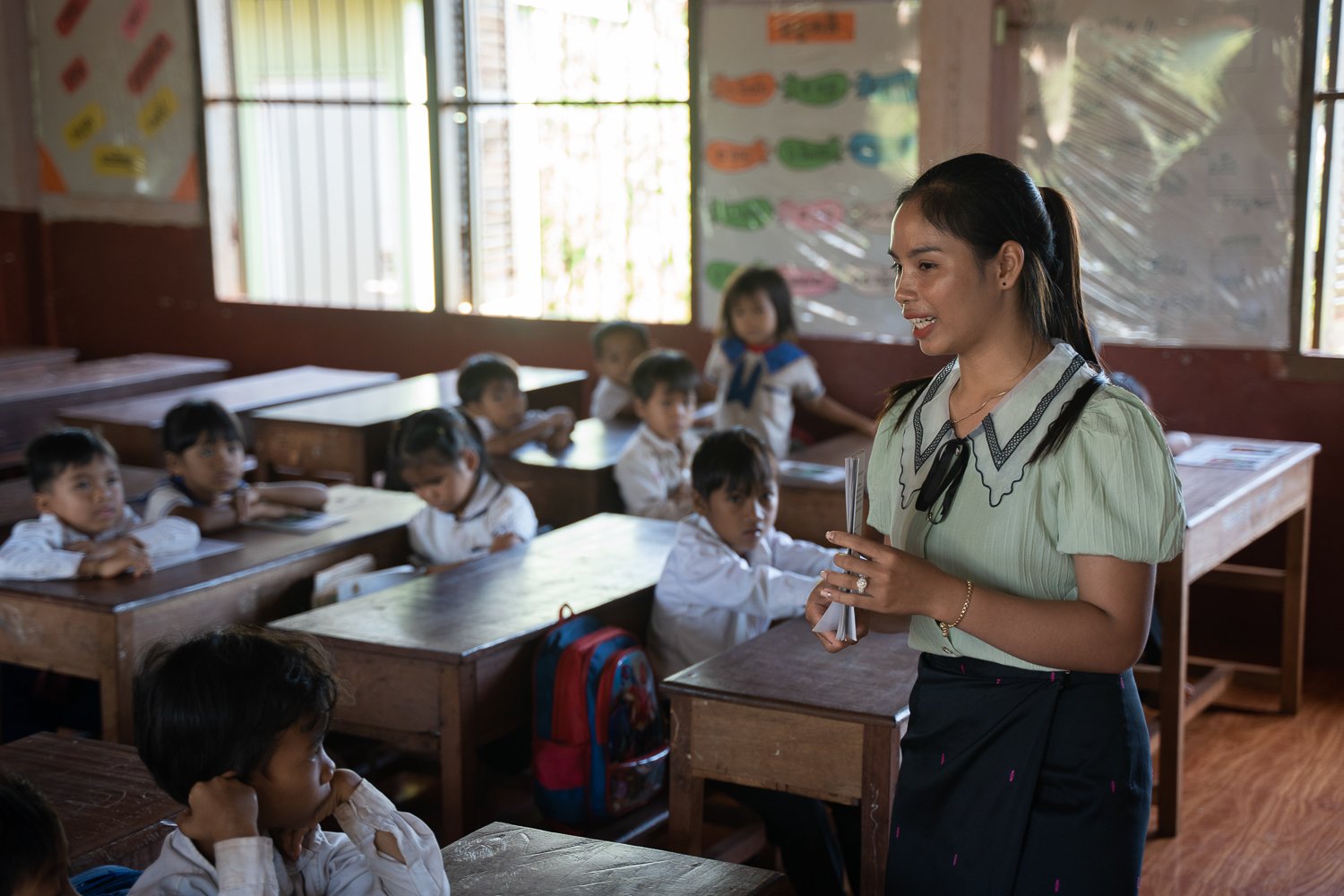 Langhav Nangminh reads a book to the class, at a primary school in Ratanikiri Province, Cambodia