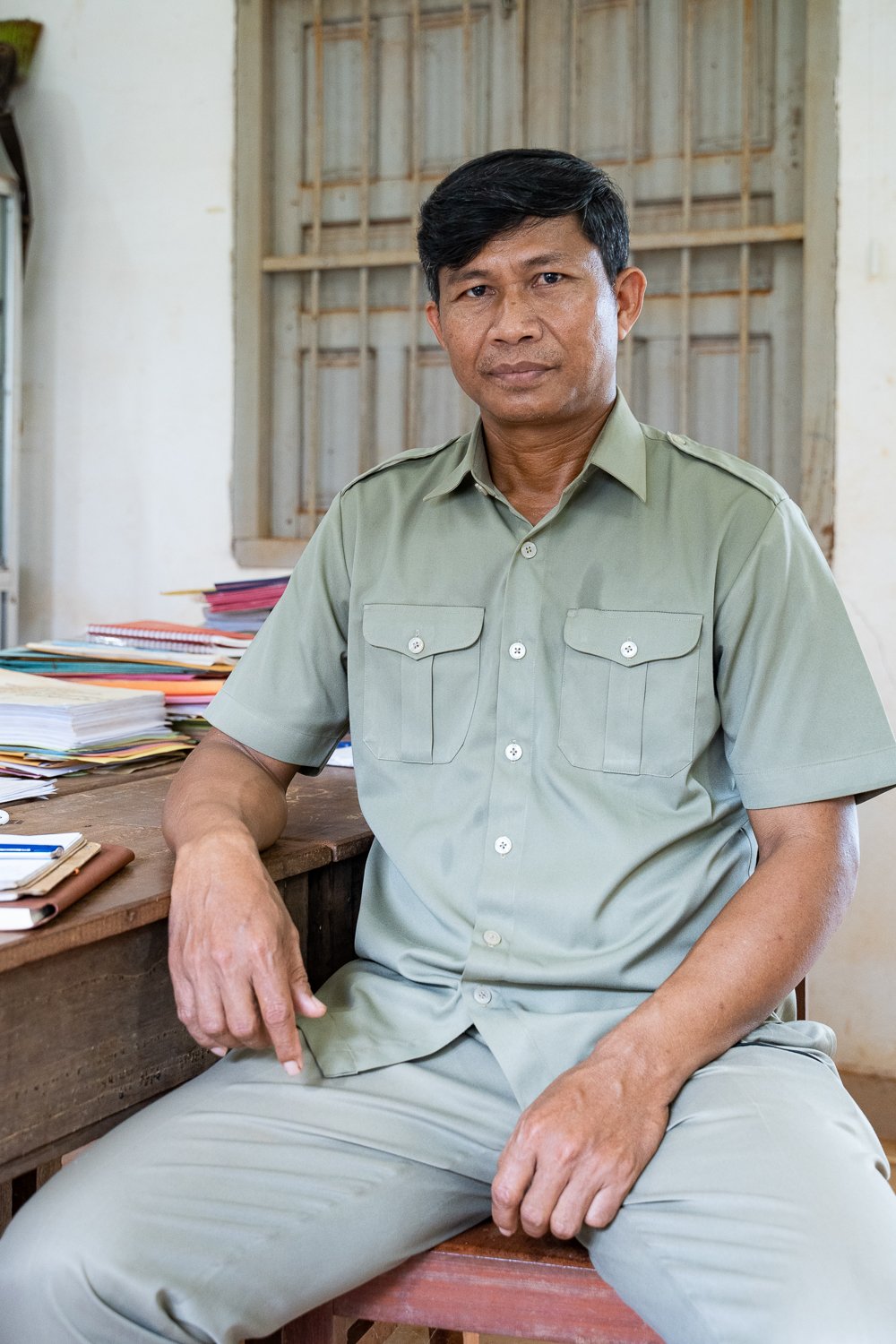 Somrith Sarom, Director of Ochum District Office of Education, Youth and Sports, poses for a portrait in his office
