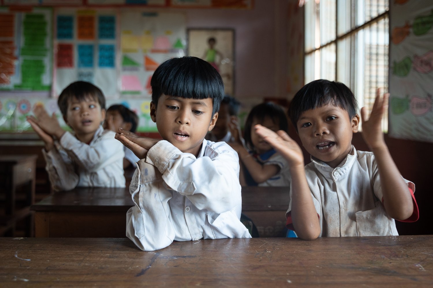 Nhu Siha (L) and Moeung Sovan (R) take part in a song in class, Cambodia