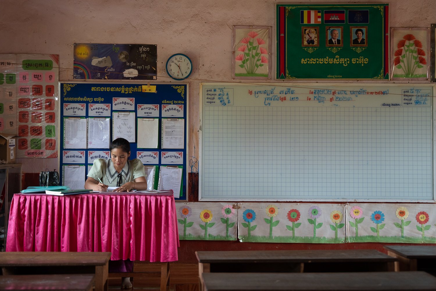 Langhav Nangminh sits at her desk and marks some homework