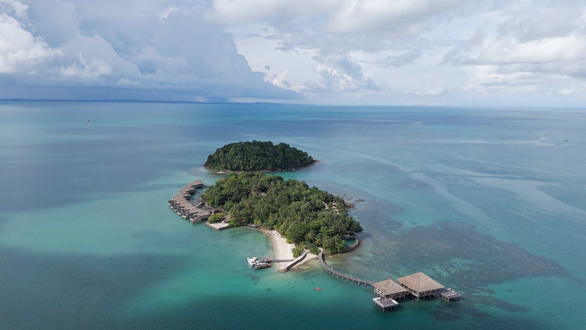 Drone aerial of Song Saa Private Island with its overwater villas and restaurant in the Koh Rong Archipelago, Cambodia