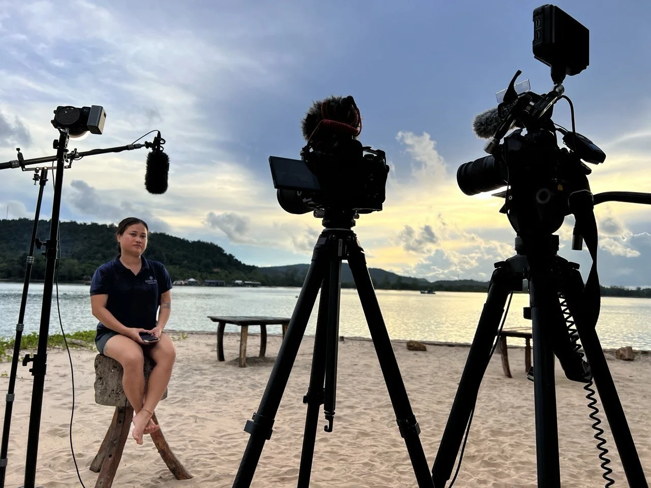 Two-camera interview setup with Morokot Long of the Song Saa Foundation on a beach in the Koh Rong Archipelago, Cambodia, at sunset