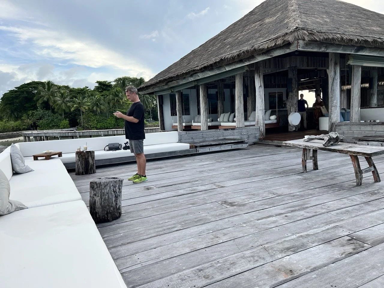 Drone operator George Jefferies flying a DJI Air 3 from a deck on Song Saa Private Island, Cambodia