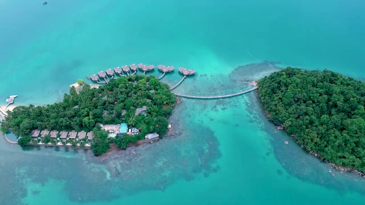 Overhead aerial view of the two islands of Song Saa Private Island, joined by a footbridge over the house reef, Koh Rong Archipelago, Cambodia