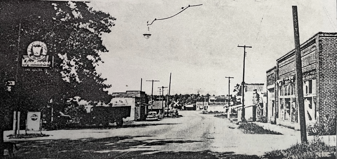 Historic photo looking at Downtown Sims from corner of Main Street and Wall Street