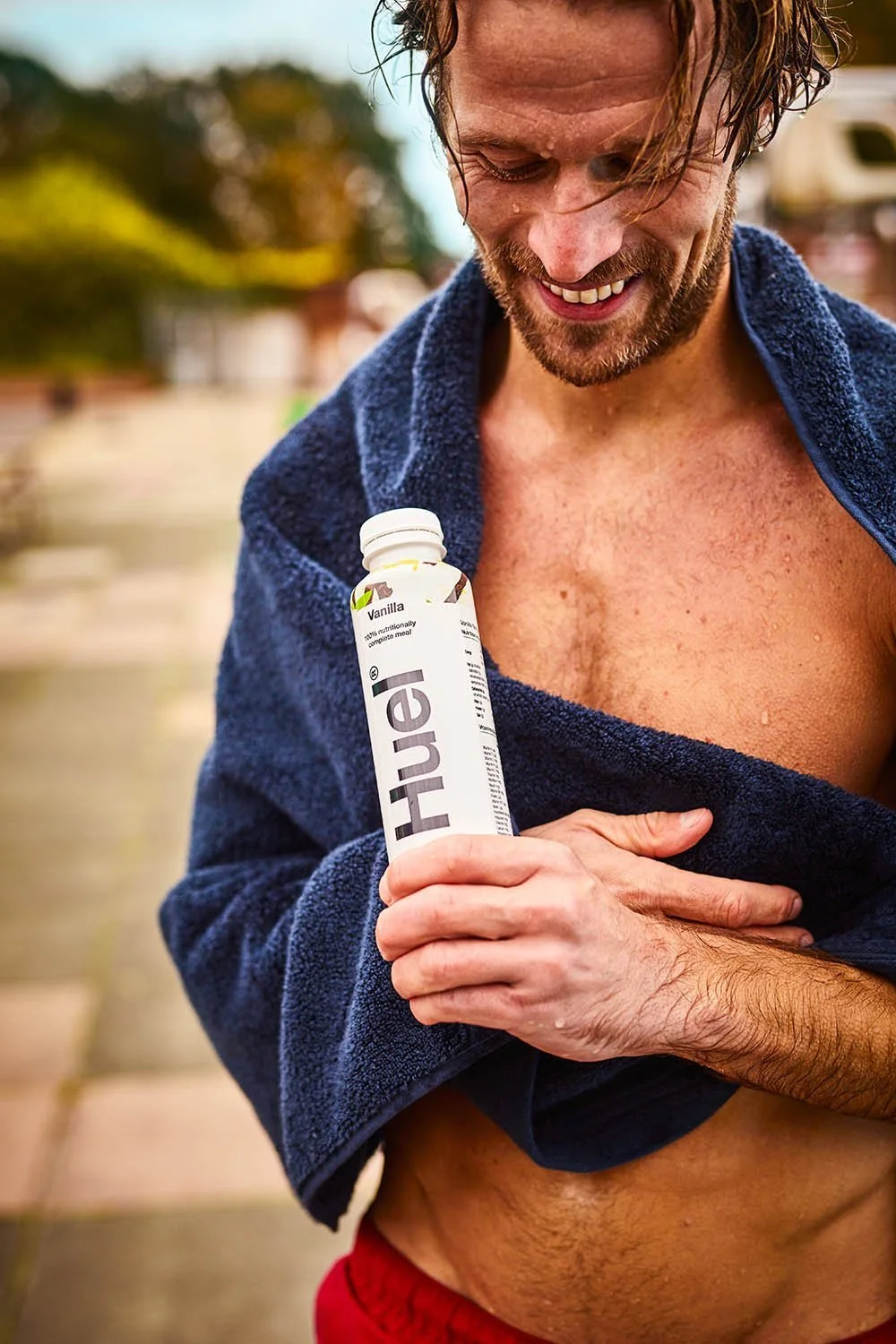 A man drys off and drinks at Huel in this lifestyle image by london based photographer Jon Enoch