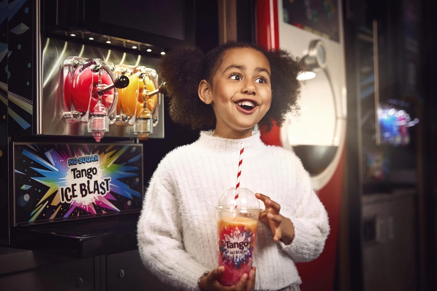 A young girl fills up her drinks cup at a Vue cinema in this lifestyle photography by advertising photographer Jon Enoch