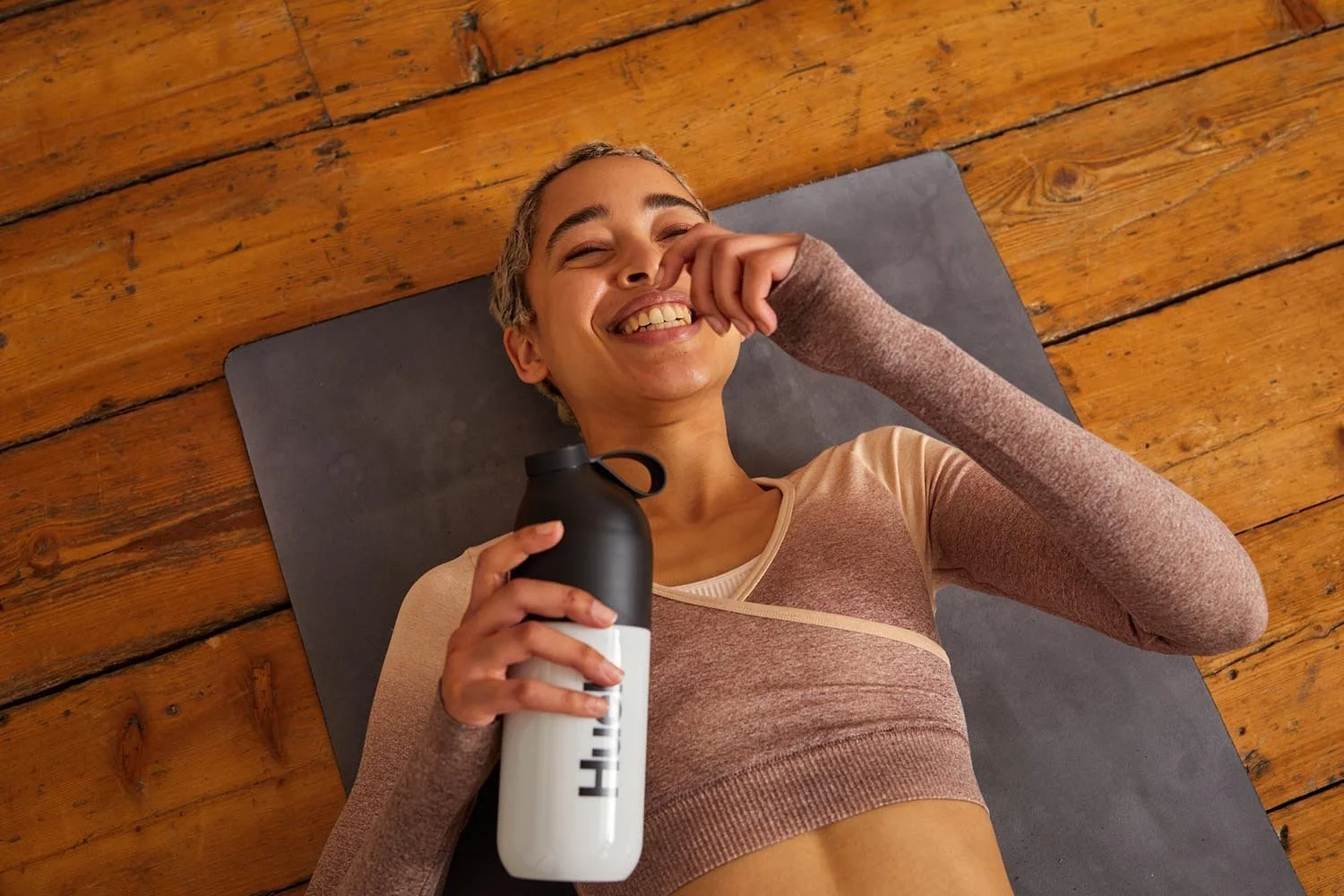 A women lays on the yoga man laughing in this lifestyle image from Jon Enoch that captures an authentic moment