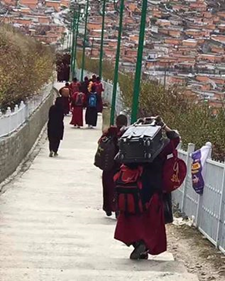 Residents leaving Larung Gar with their possessions