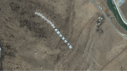 Larung Gar's south west corner in April 2017, showing the addition of a Chinese propaganda slogan opposite the main entrance of the site (Apollo Mapping)