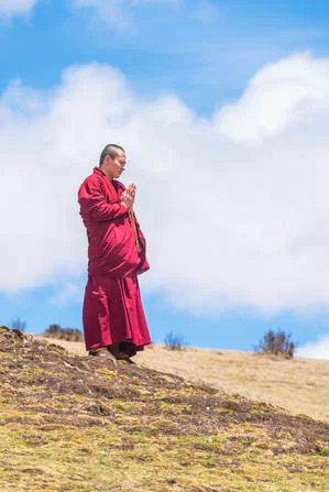 Monk praying during a sky burial at Larung Gar in 2016 (Jesse Rockwell)