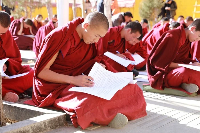 Monk taking a Chinese law exam. Ganden Monastery in Lhasa.