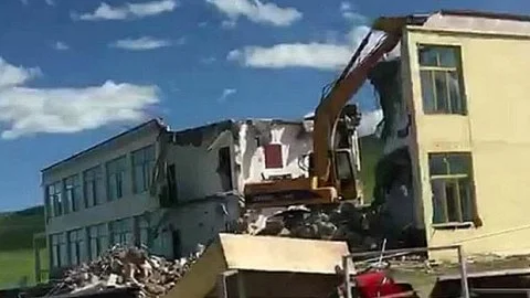 A Tibetan building is torn down near Qinghai Lake
