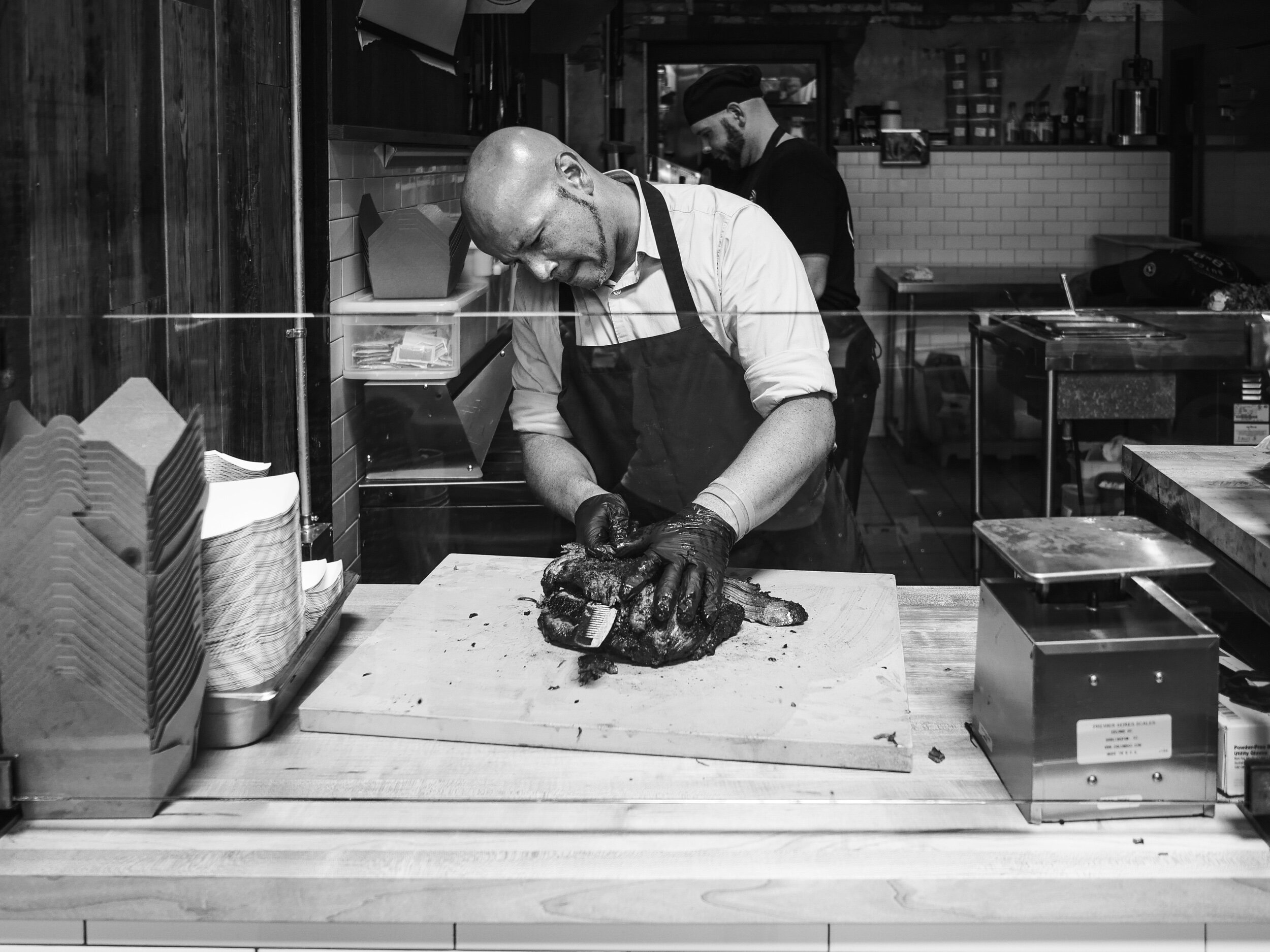 Pit master slicing up BBQ brisket