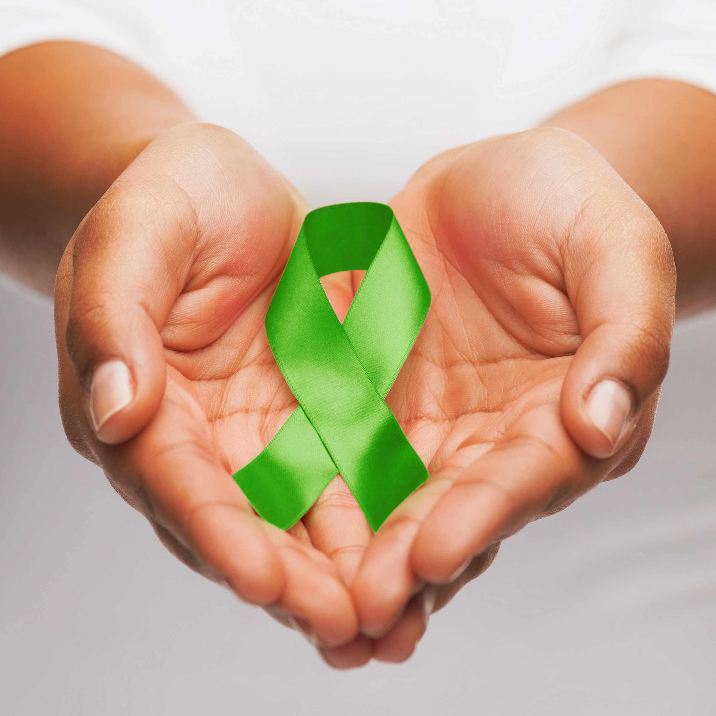female-hands-holding-green-organ-transplant-awareness-ribbon-1x1.jpg