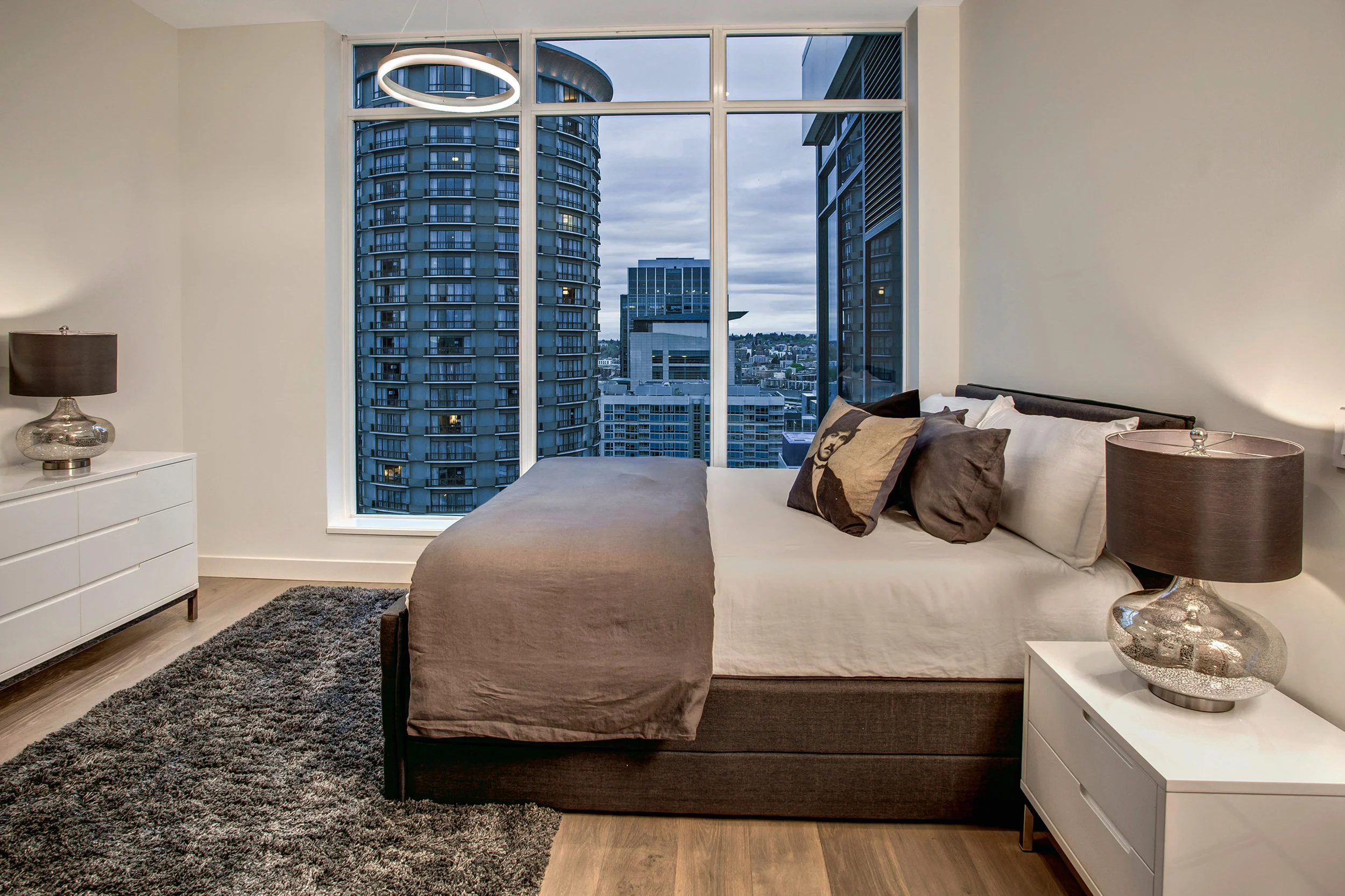 Guest room with en suite bathroom, floor to ceiling windows, and custom built closet.