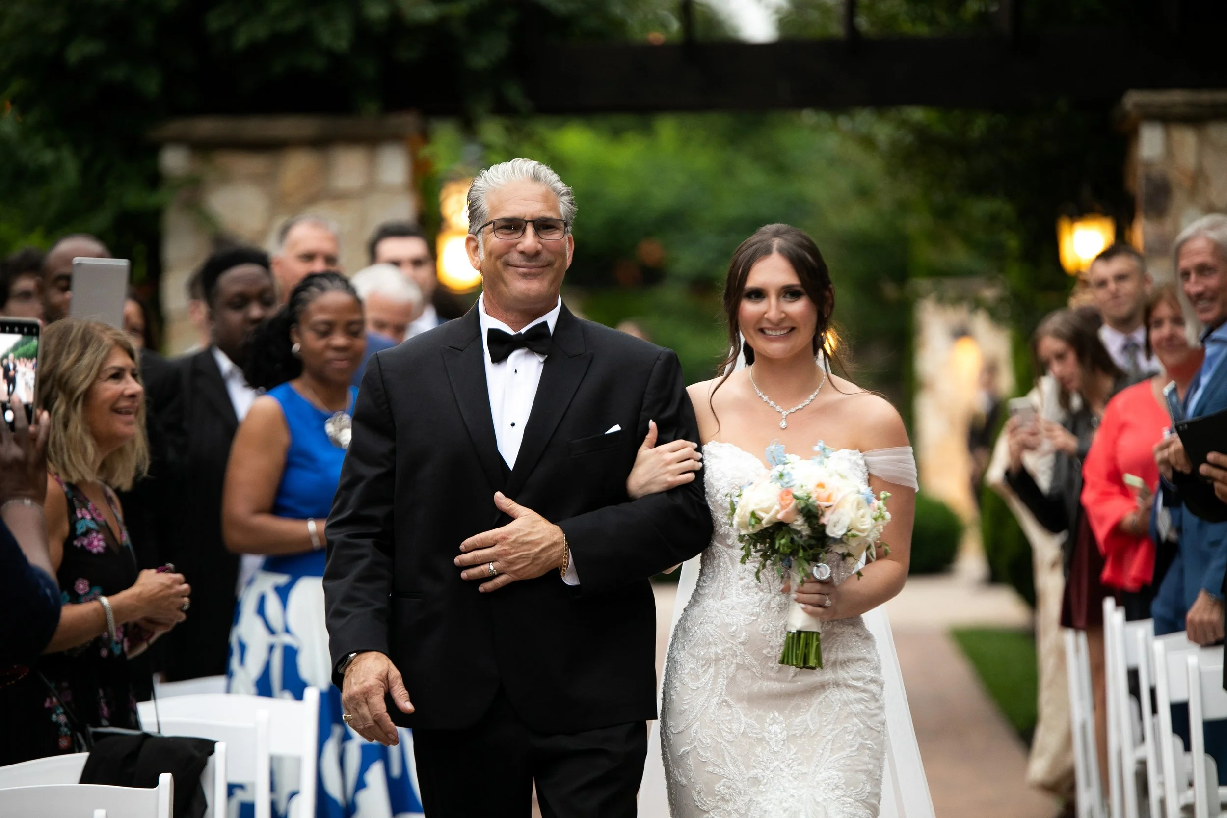 Father of the bride walking down the aisle with his daughter