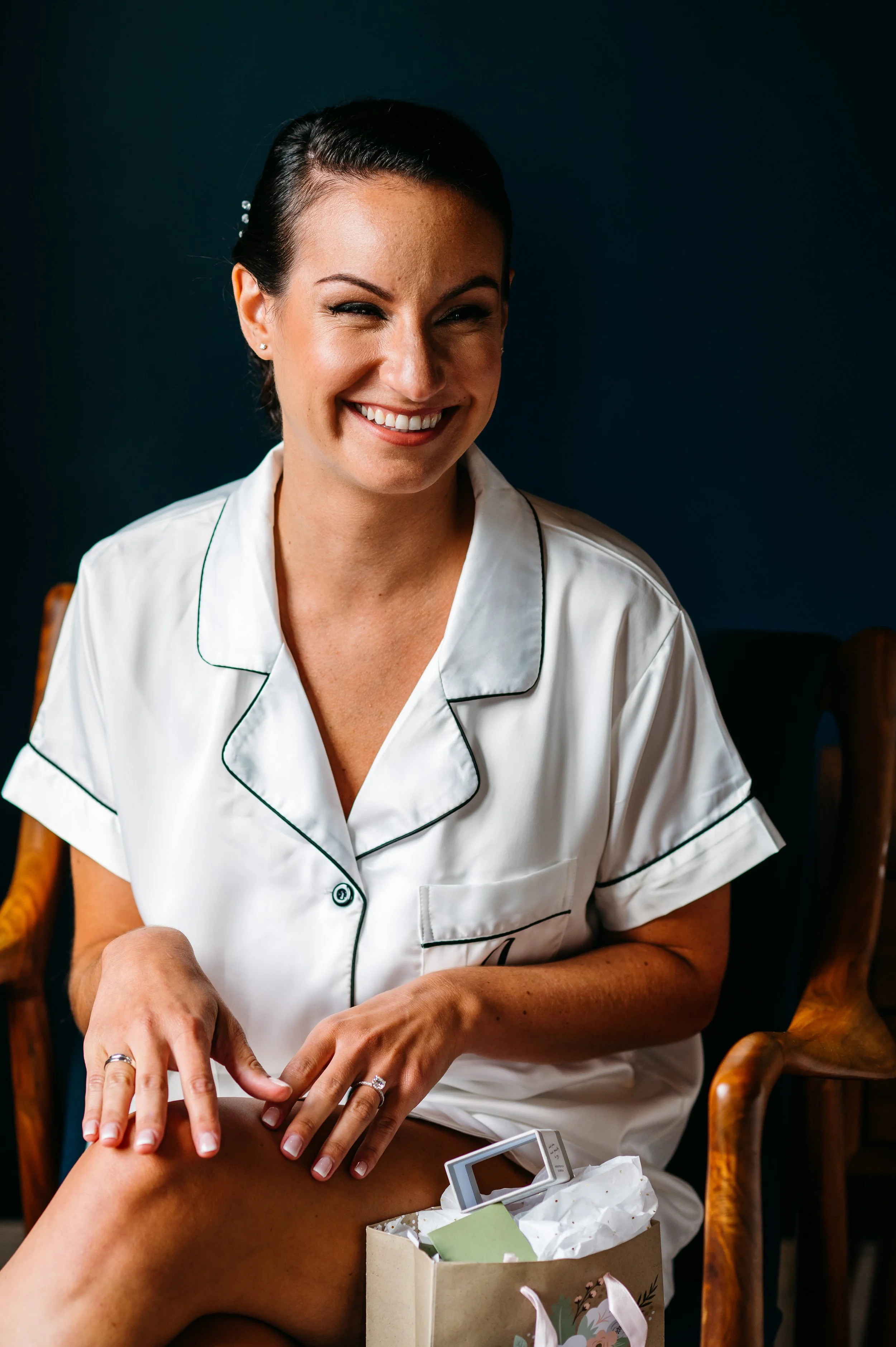 Bride wearing white pajamas on her wedding day showing off her nails
