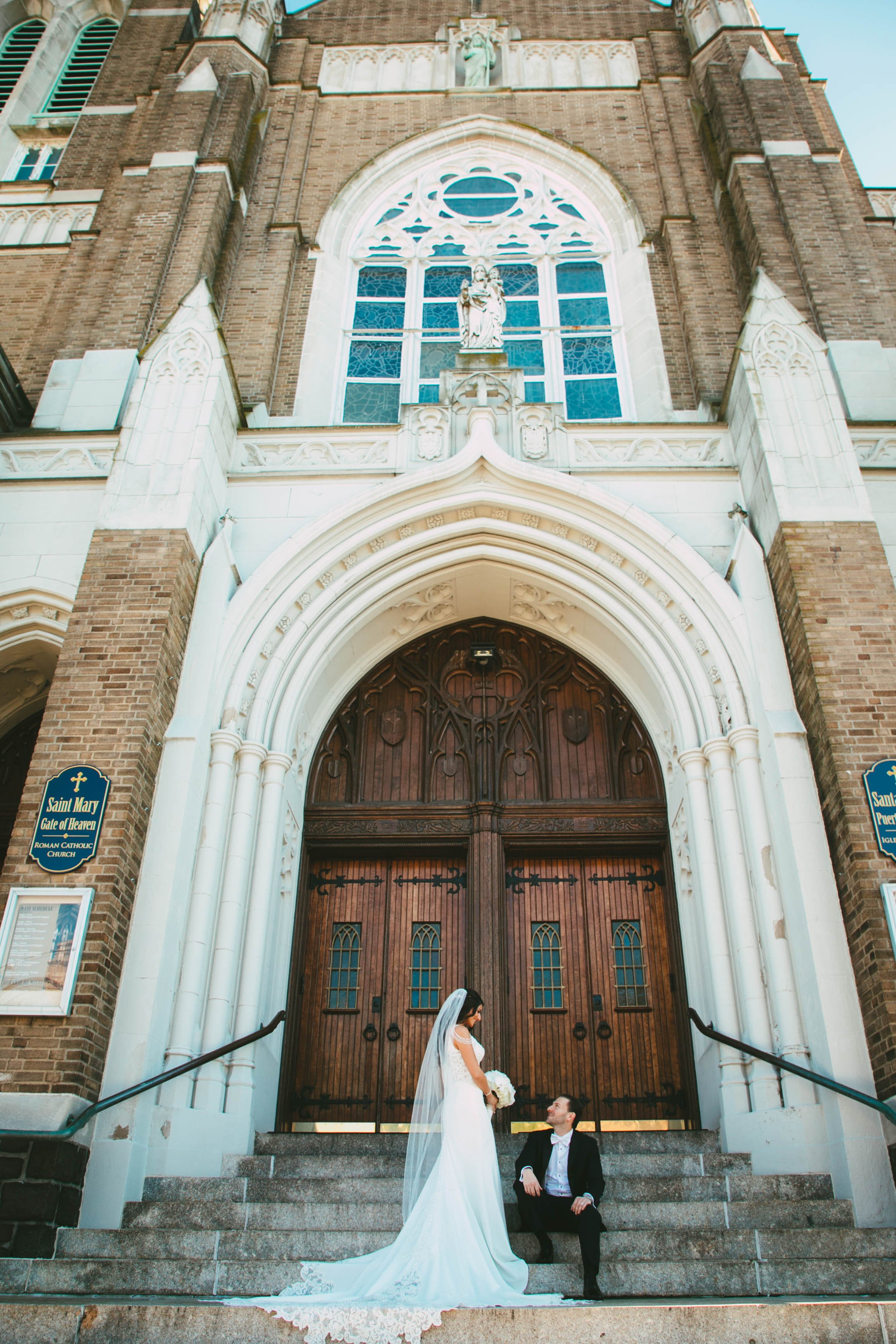 Wedding photo of bride and groom sitting on church steps