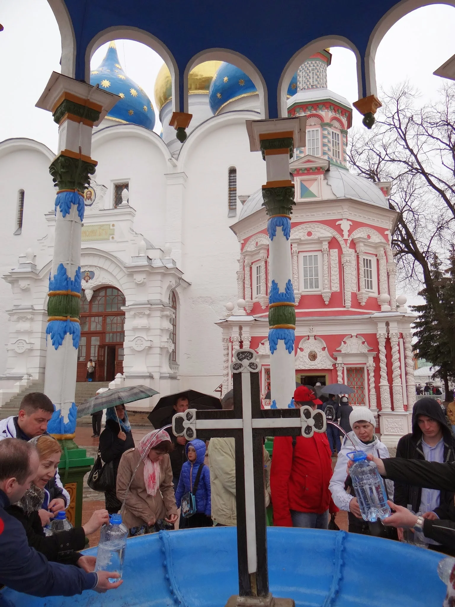 People collecting holy water from a well. The well was discovered in 1644 and has its own chapel attached.