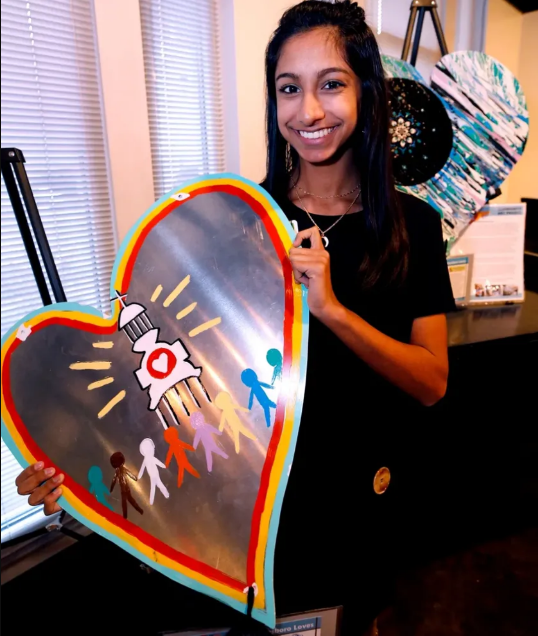  Mira Patel with the heart she painted for a community project. 