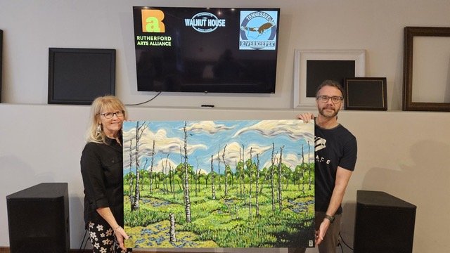Pam Mack and Gregory Lannom with his painting