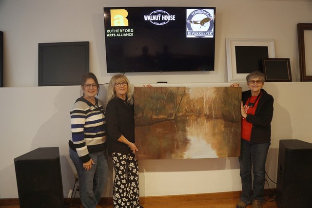  Susan Gulley, Pam Mack, and Suzanne LeBeau with Suzanne’s painting. 