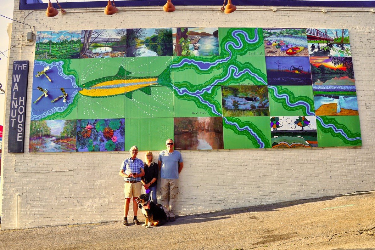 Project volunteers Tommy Womack, Pam Mack, Ricky Martini, &amp; Sydney in front of completed mural