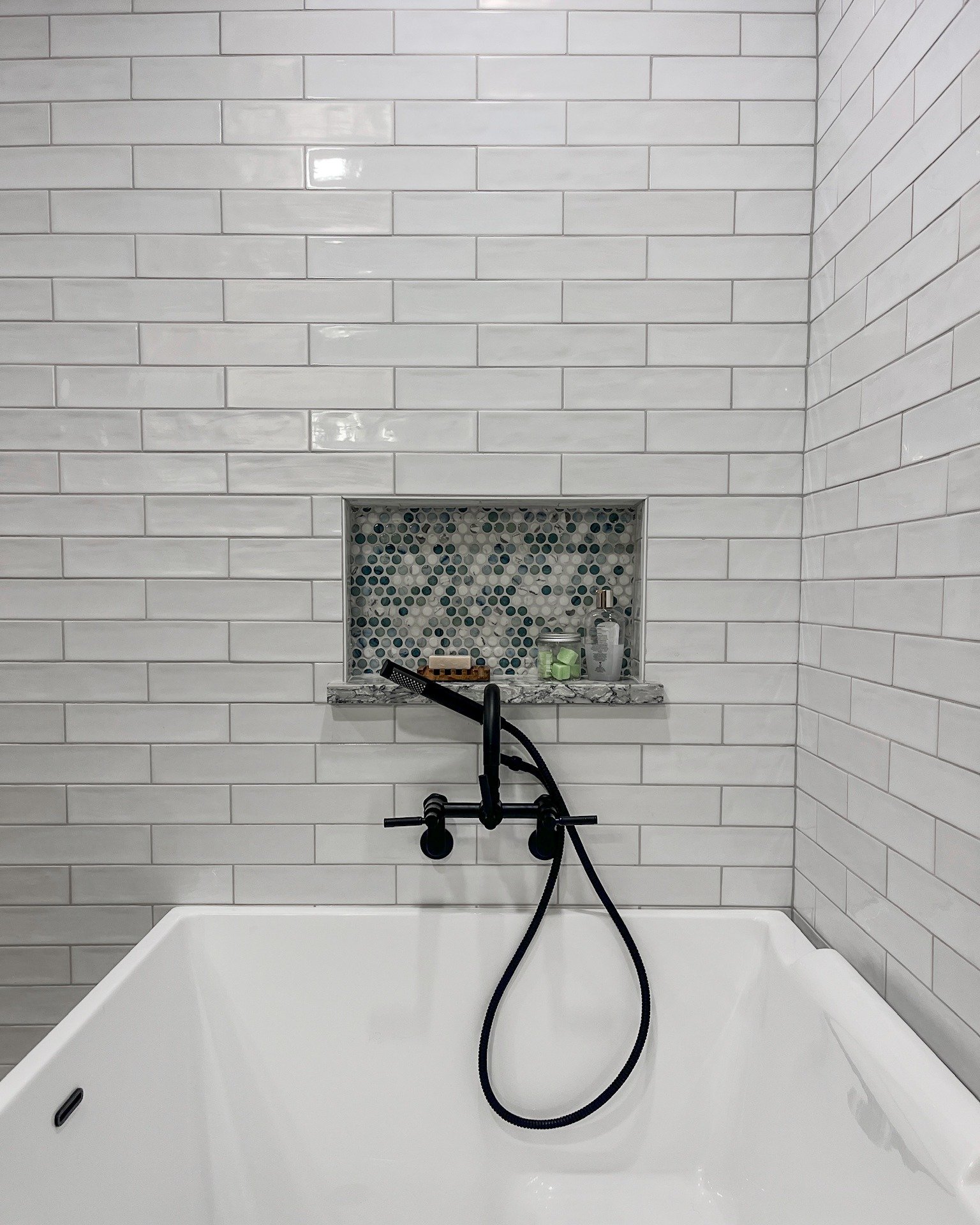 It&rsquo;s the details that bring a bathroom together.

In this space, layered tile selections and a sculptural countertop-and-sink combination do the heavy lifting&mdash;creating cohesion, contrast, and quiet interest at every turn. Crisp wall tile 