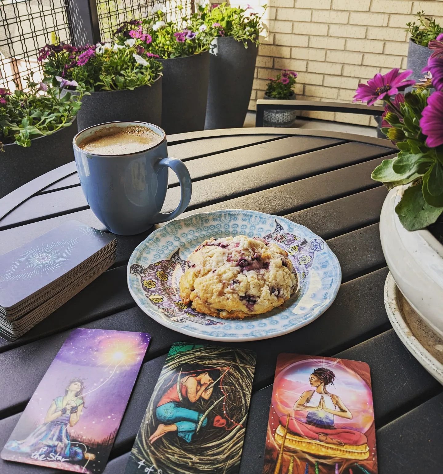 I start every morning with a card pull at breakfast. If I haven't been listening to my intuition or paying attention to signs, my guides know I'm available and listening every morning. Today it's on the balcony with Mother's Day flowers and my favori