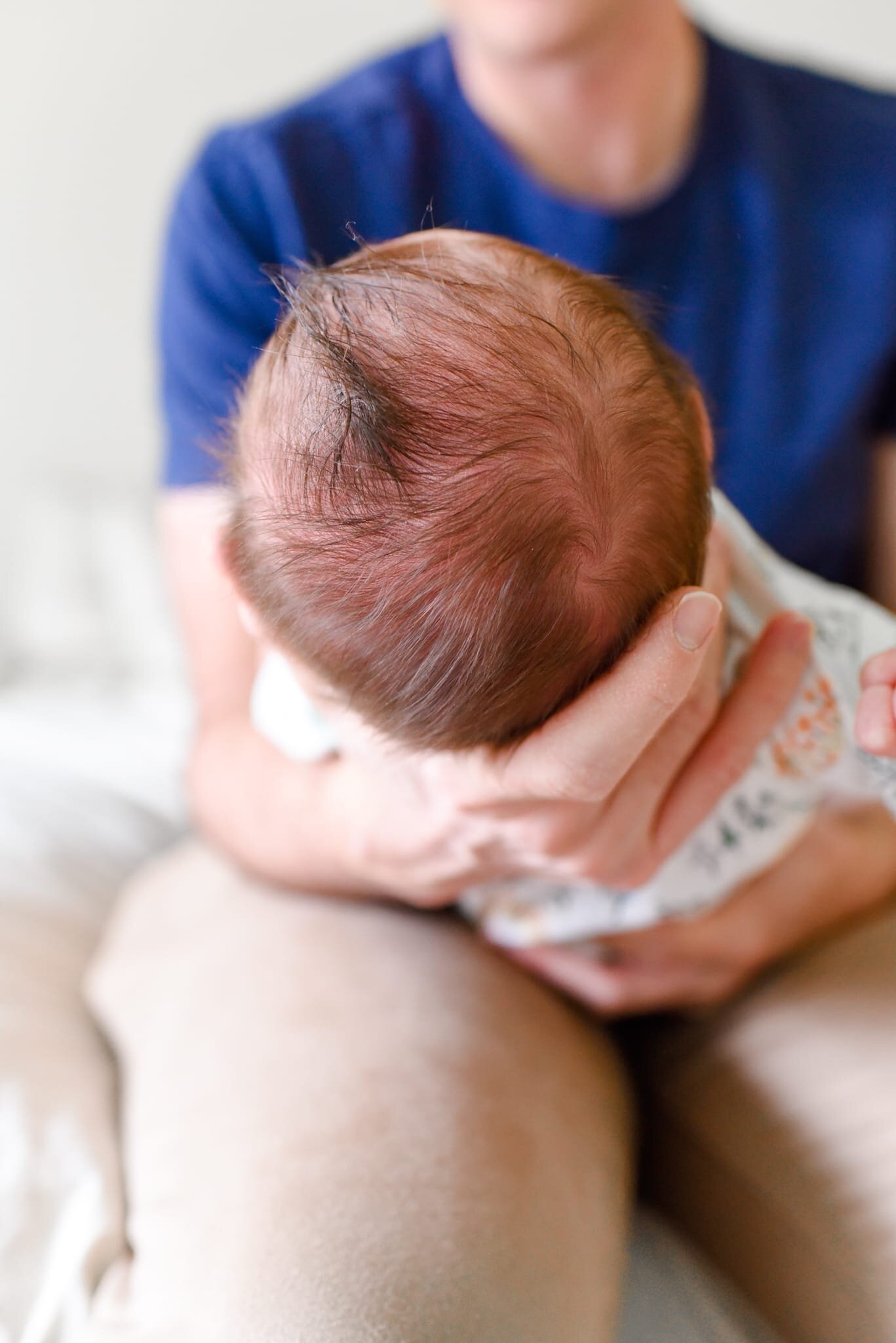 Rockville Maryland Newborn Photographer - close-up of baby's head in dad's hands