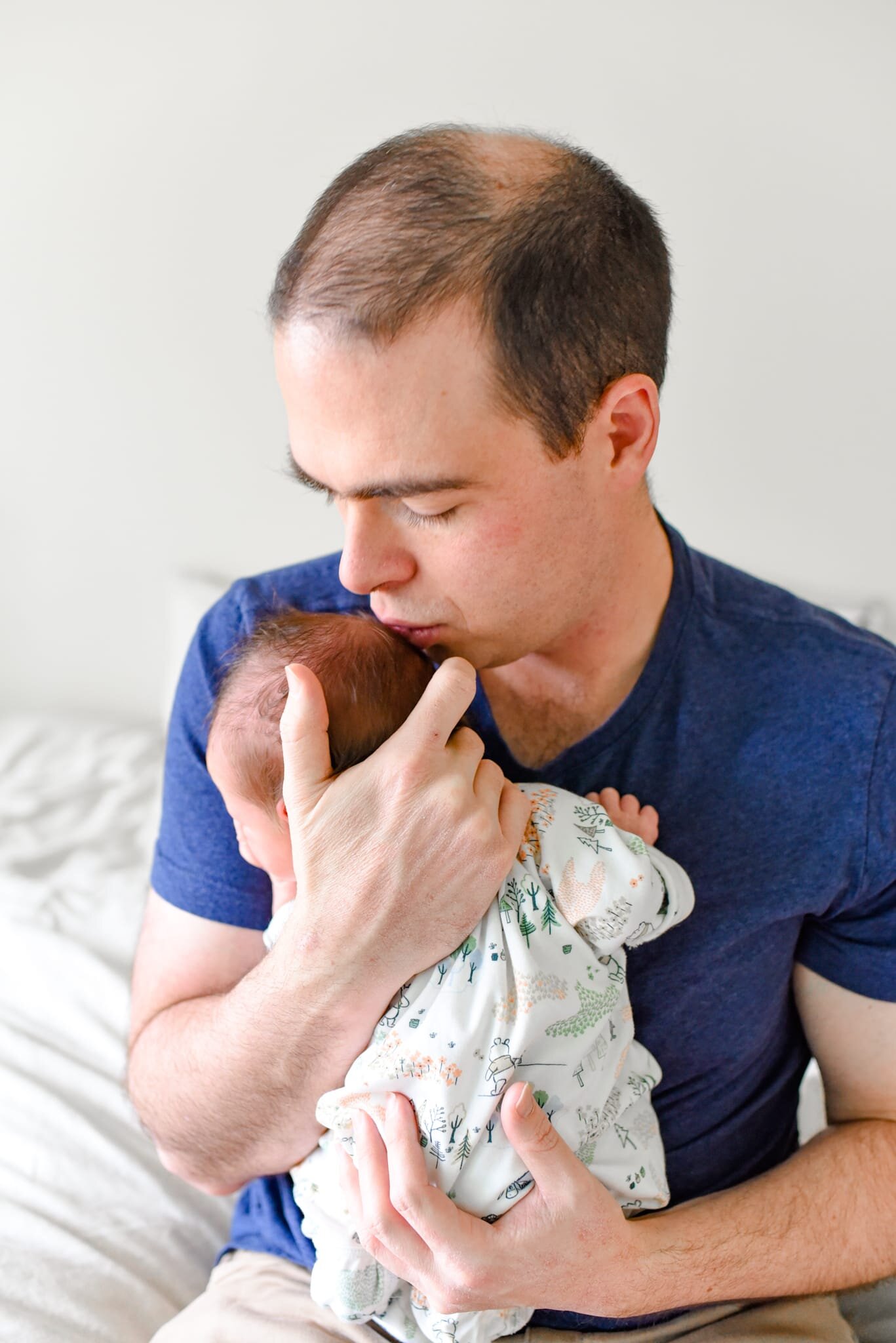 Rockville Maryland Newborn Photographer - dad holding baby on chest