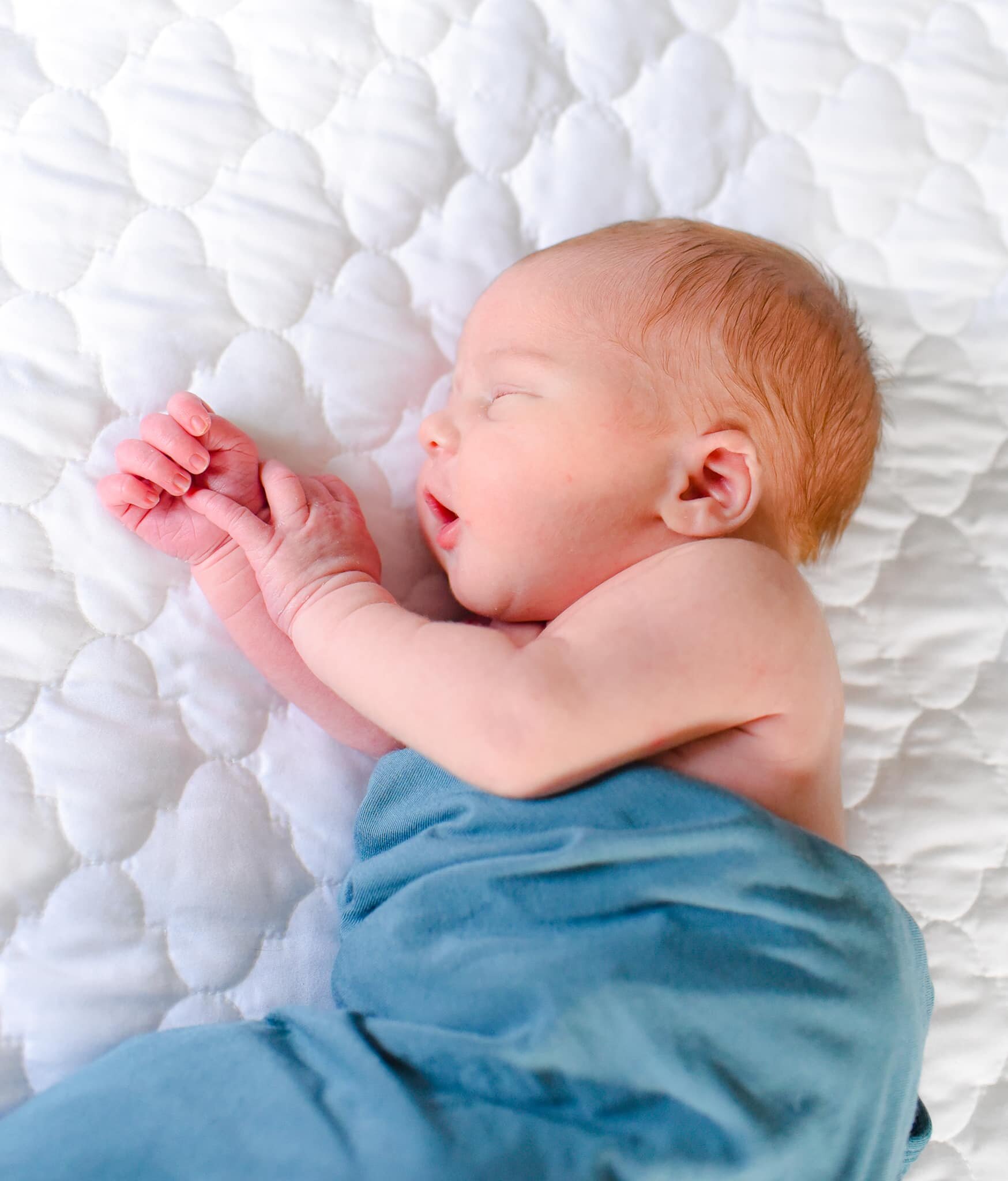 Silver Spring Maryland Newborn Photoshoot - baby sleeping on his side on the bed