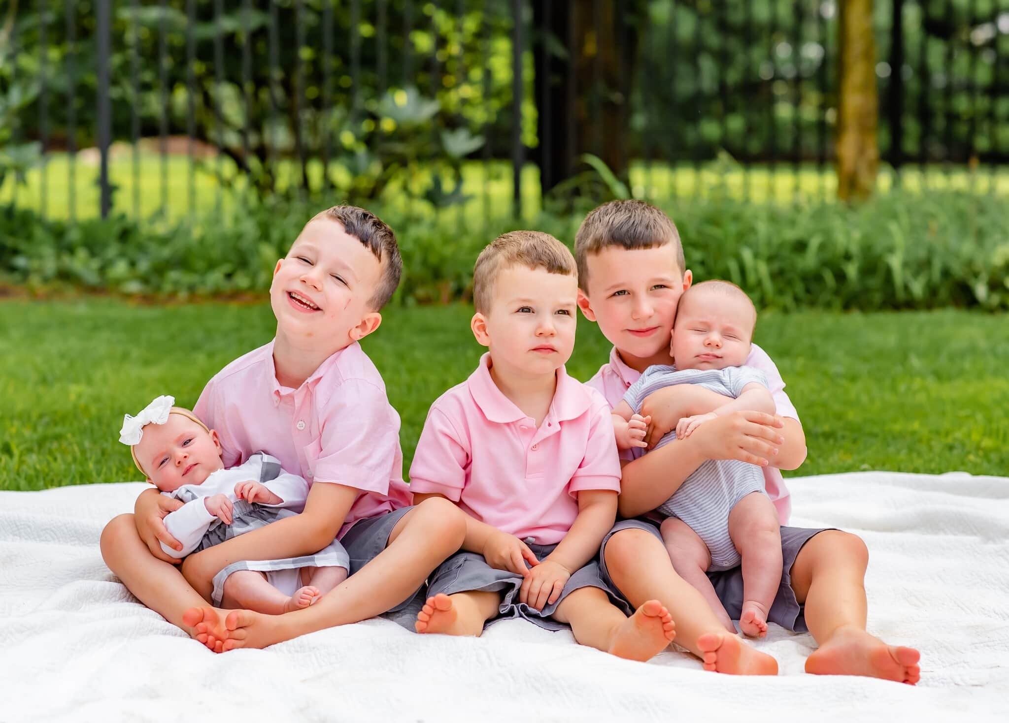 Bethesda Maryland Newborn Photoshoot - older brothers cradling baby twins