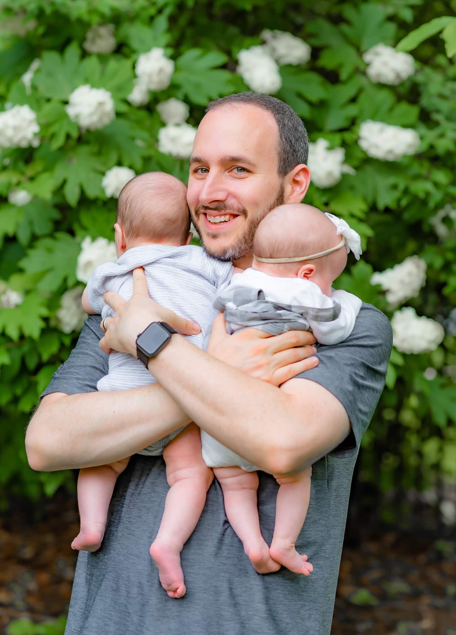 Bethesda Maryland Newborn Photoshoot - dad cradling twins