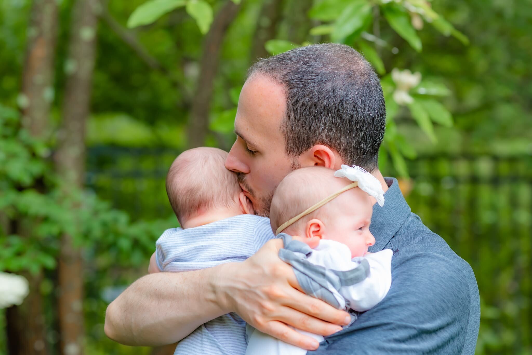 Bethesda Maryland Newborn Photoshoot - dad kissing babies