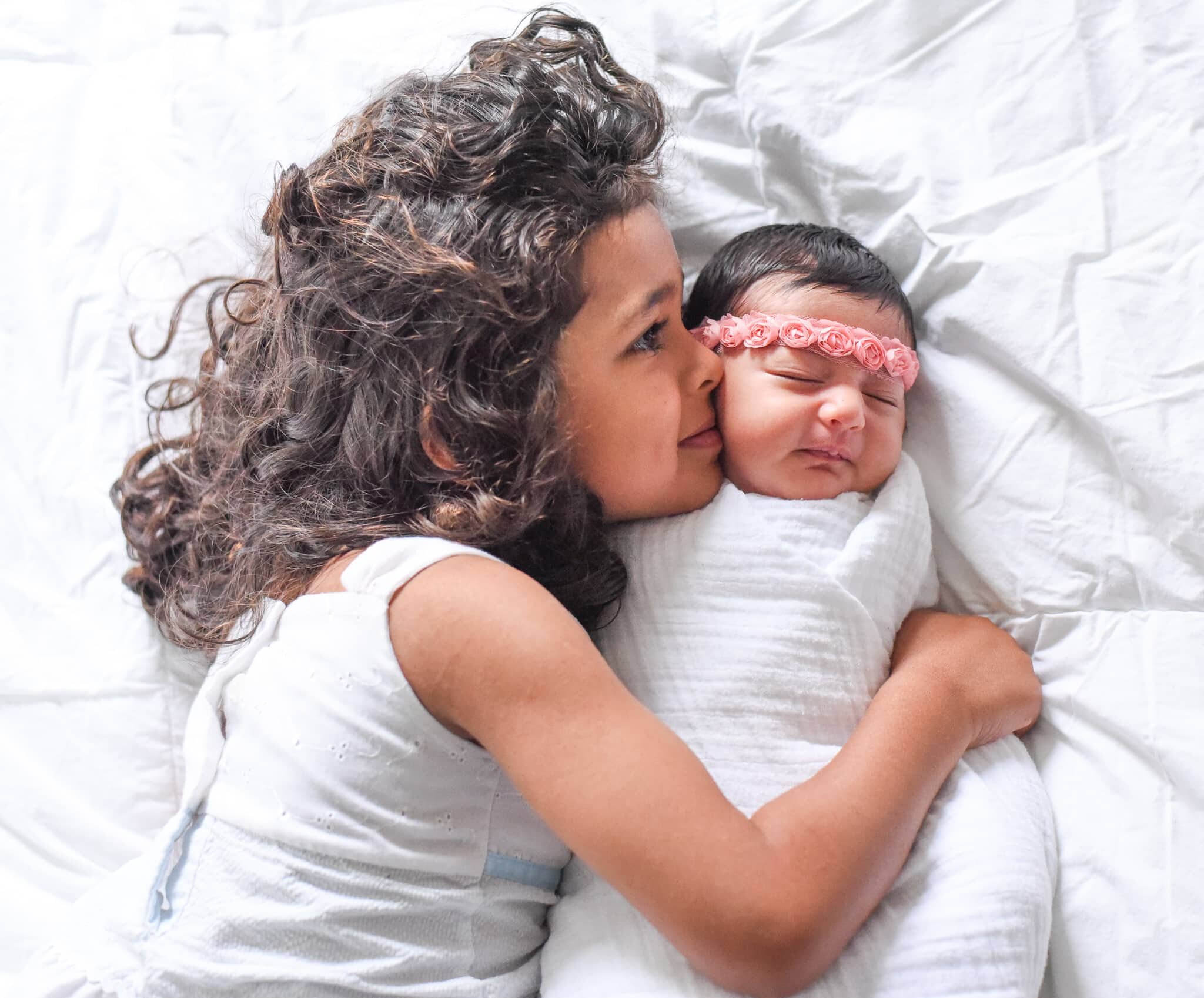 Maryland Newborn Photographer - sibling cradling baby