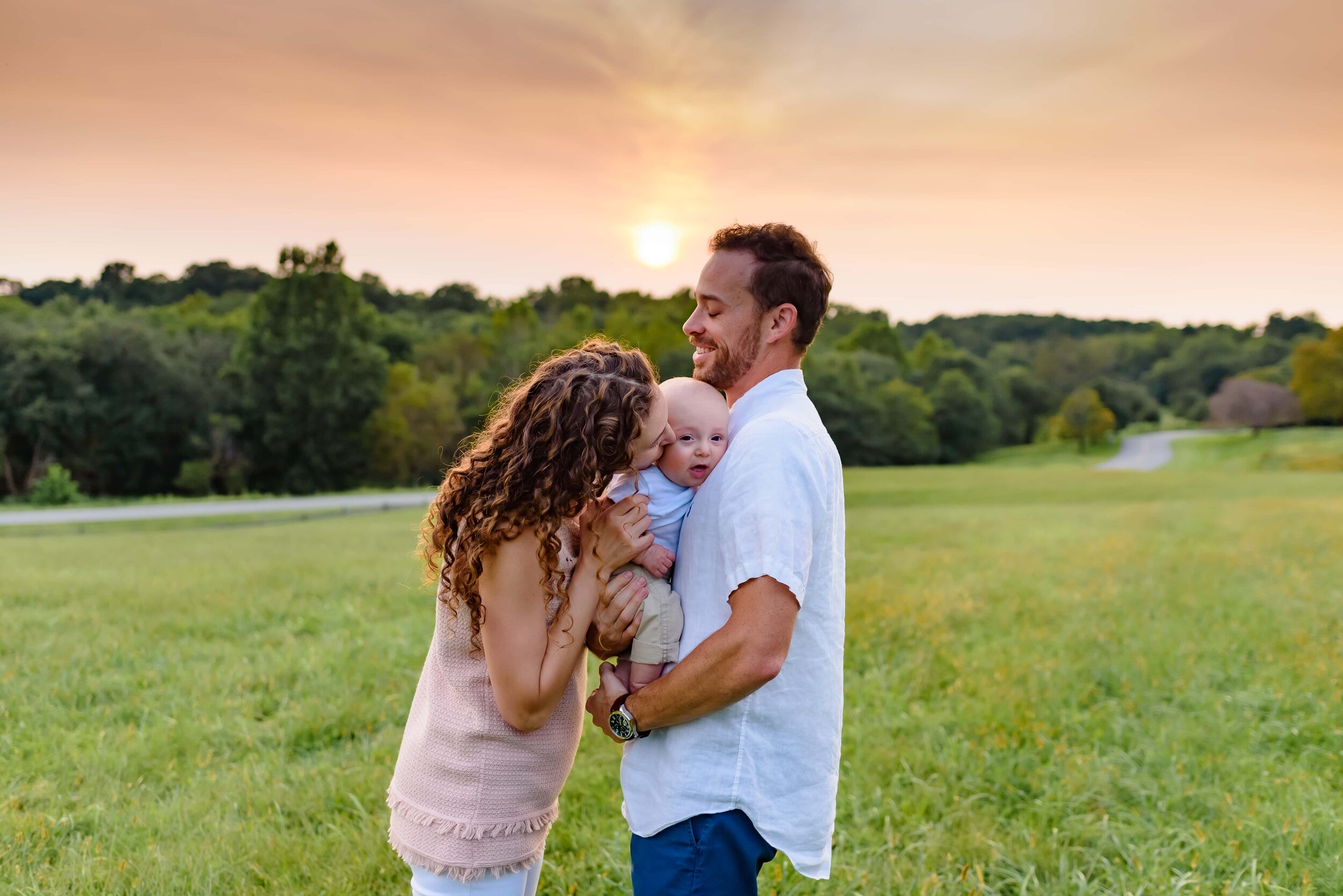 Maryland Newborn Photography - family cradling baby at sunset