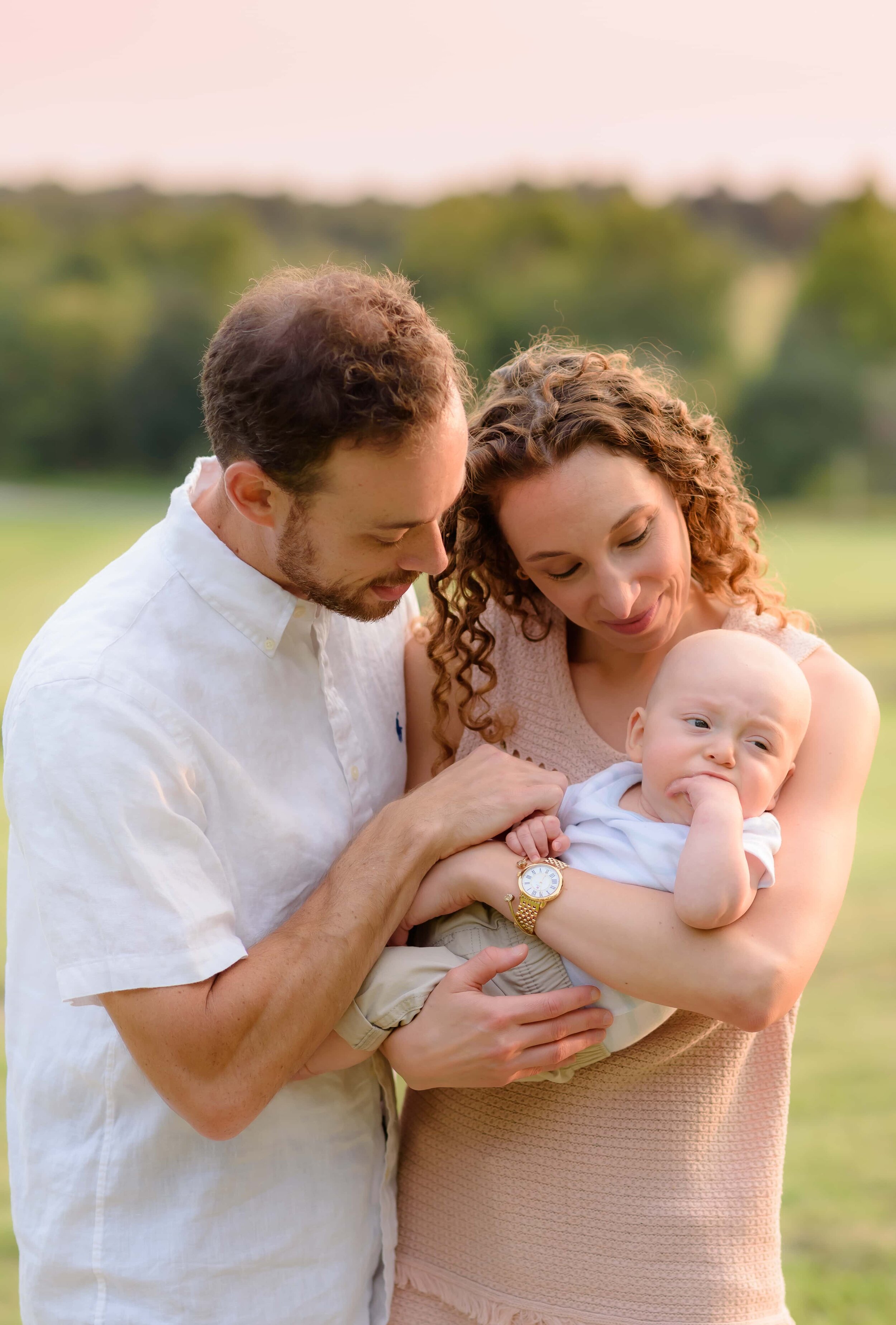 Maryland Newborn Photographer - mom and dad cradling baby