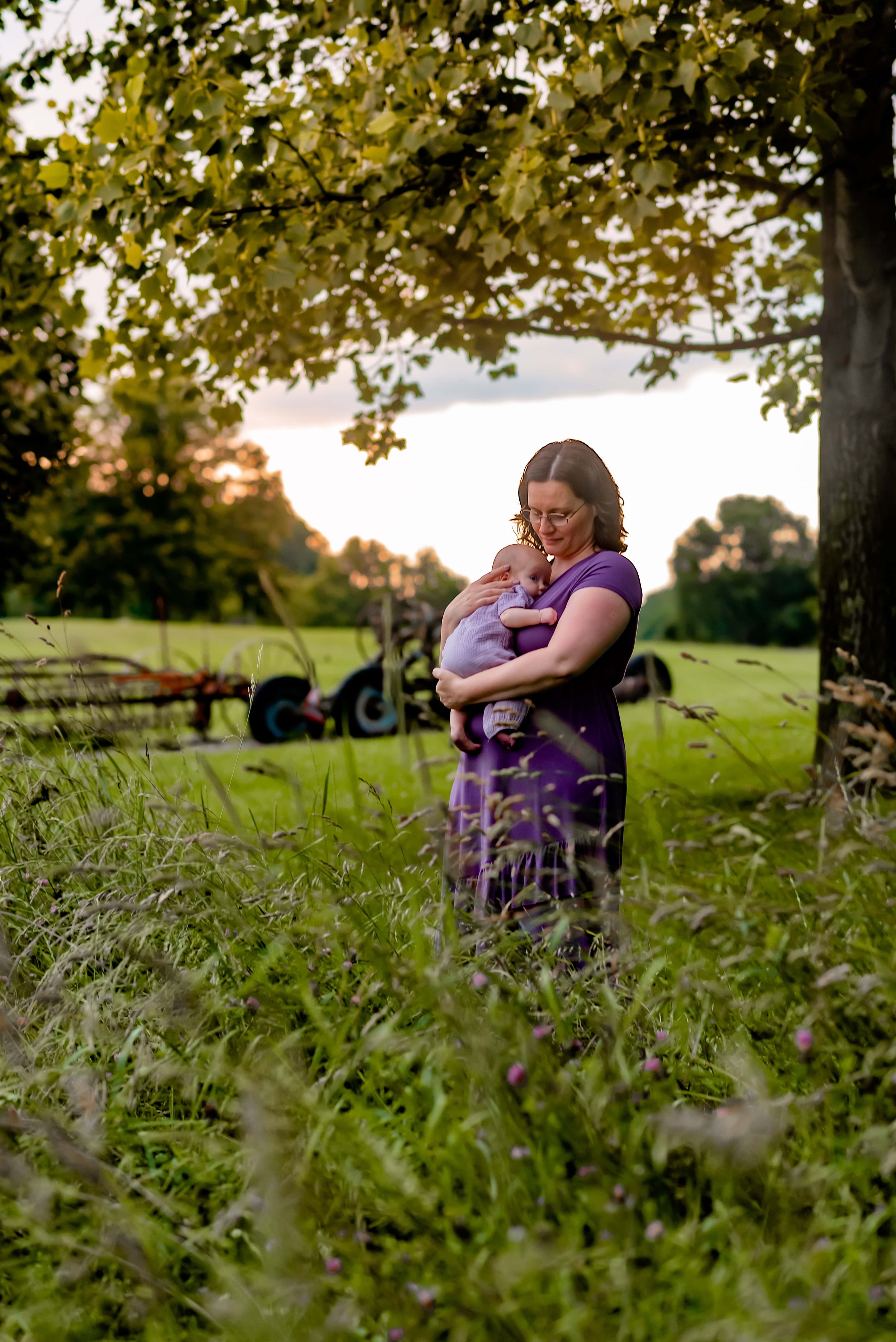 Maryland newborn photos mom and baby in a field with long grass