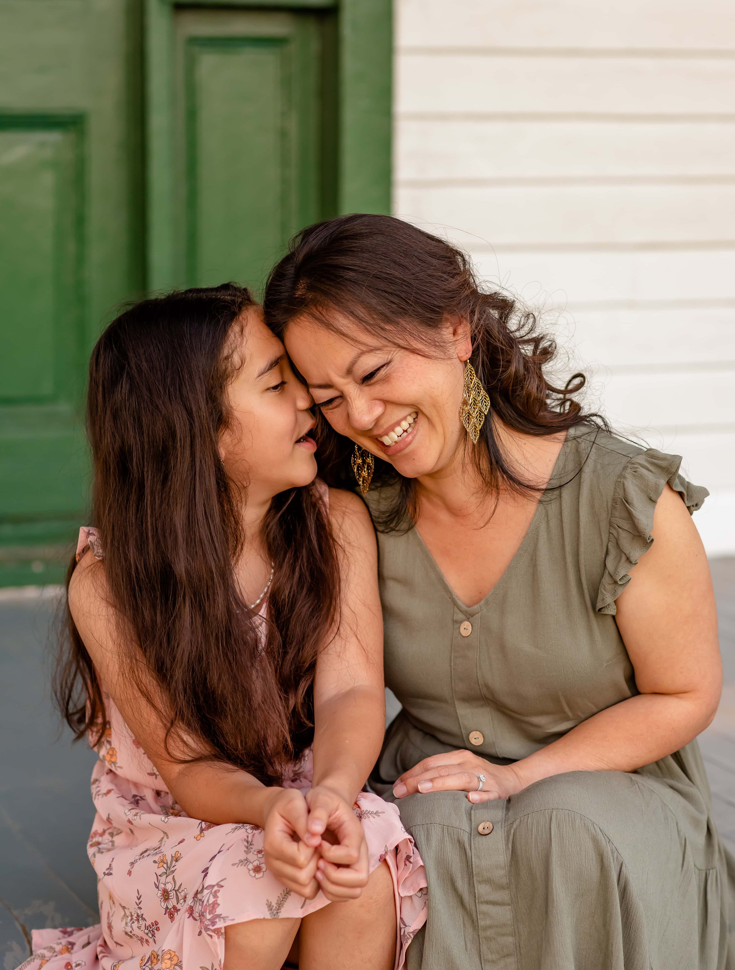 Maryland family portrait of whispering daughter and laughing mom