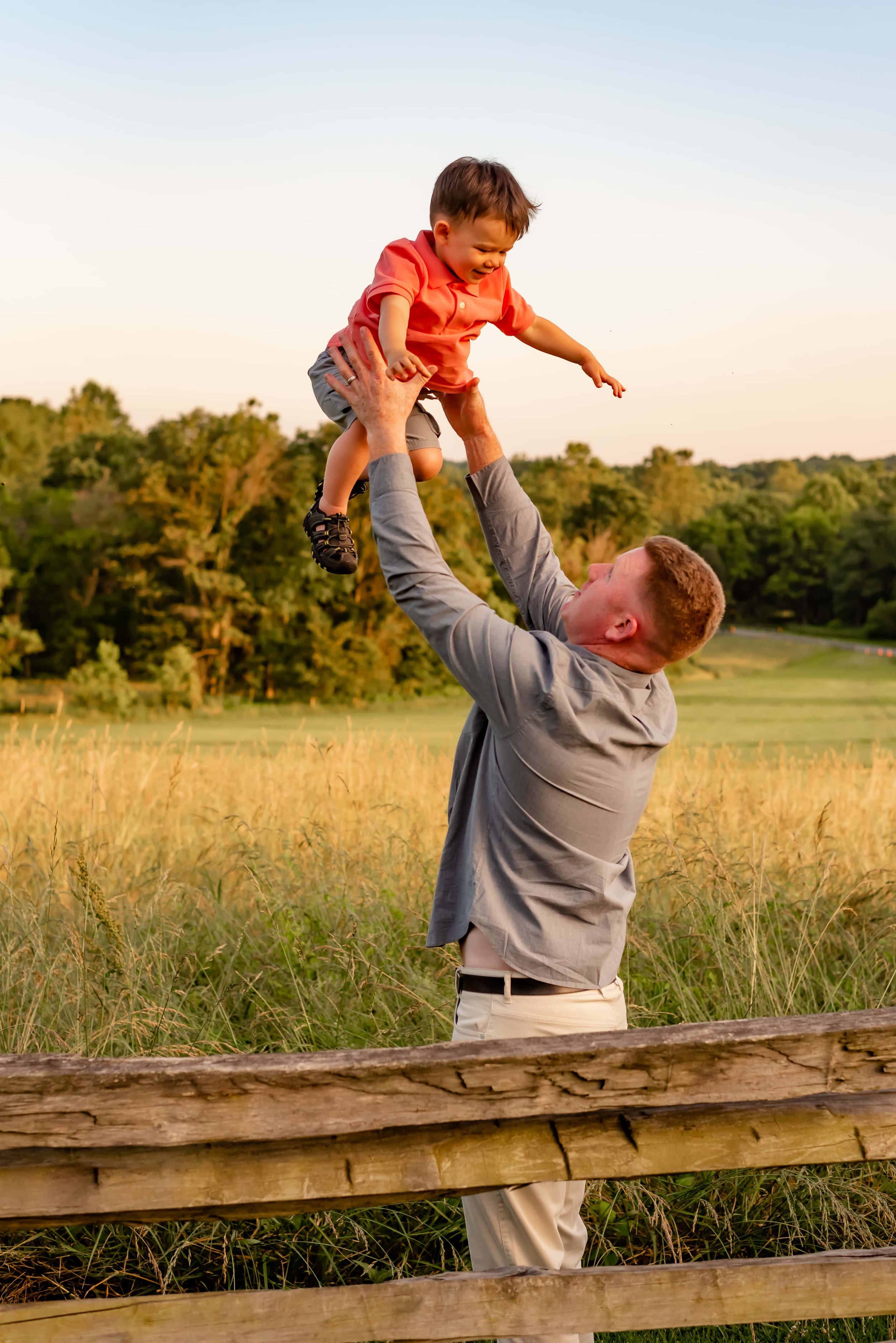 Maryland family portrait of father throwing son in the air